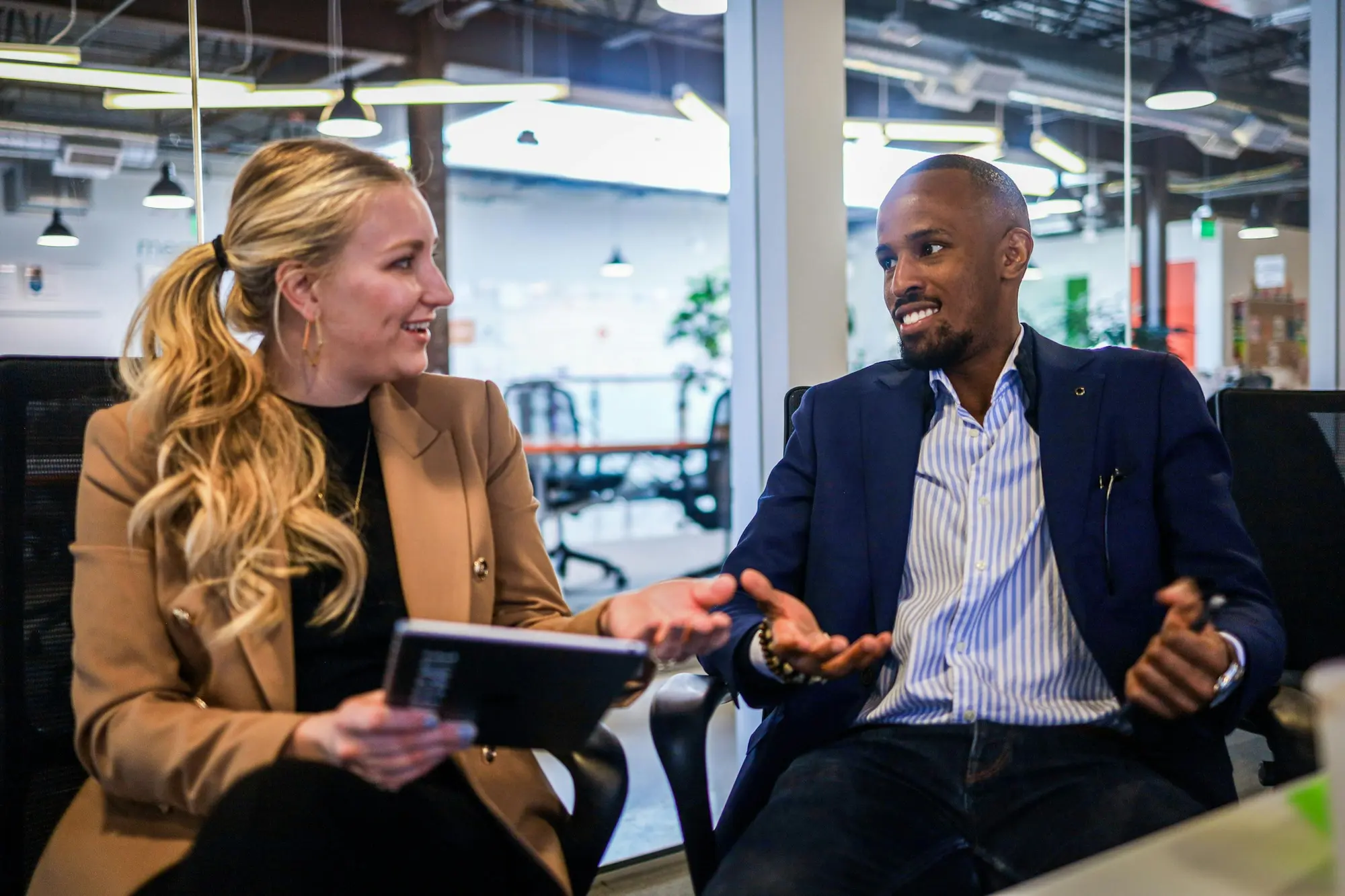Two executives in conversation during a business meeting